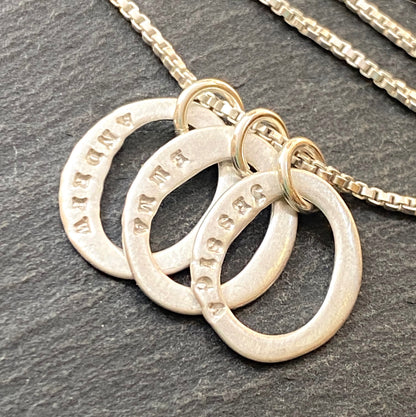 sterling silver hand stamped mom necklace with kids names on tiny organic oval ring charms- drake designs jewelry