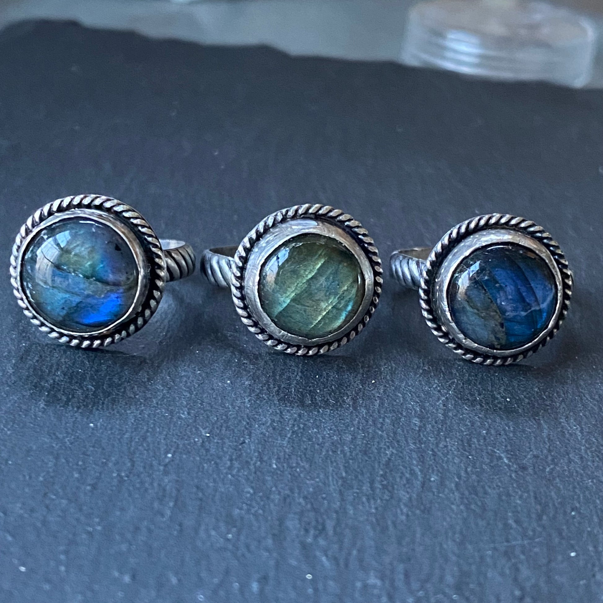 sterling silver labradorite ring hand crafted with rope band .  Labradorite with flash is hand set in sterling silver bezel - drake designs jewelry