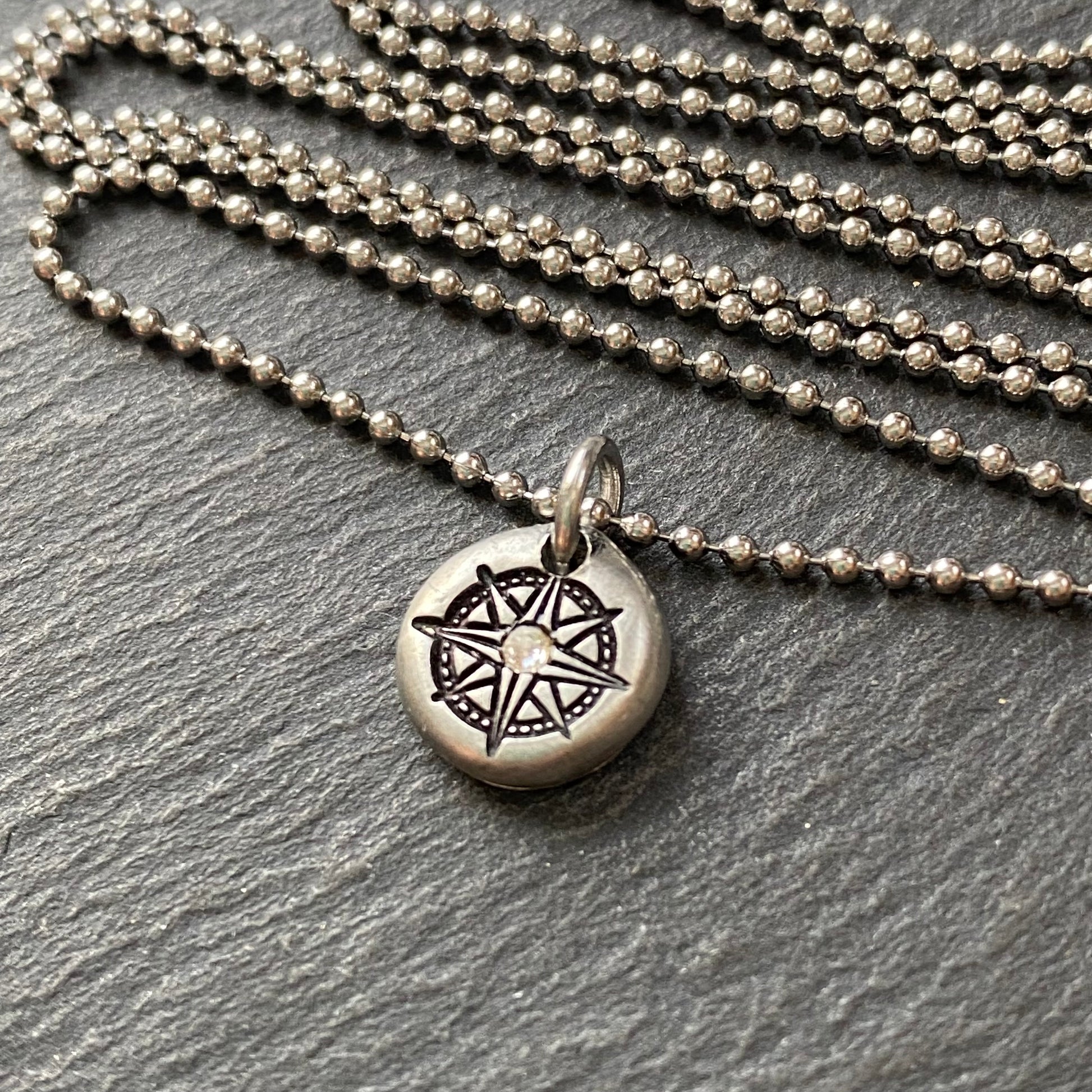 silver pebble compass necklace with hand set crystal at center - drake designs jewelry