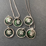 tiny green wax seal clover necklace made with recycled silver and resin. drake designs jewelry