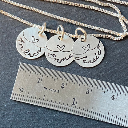 linked by love sterling silver mom necklace with kids names and heart links hand stamped. small charm necklace with childrens names linked together by love.  drake designs jewelry