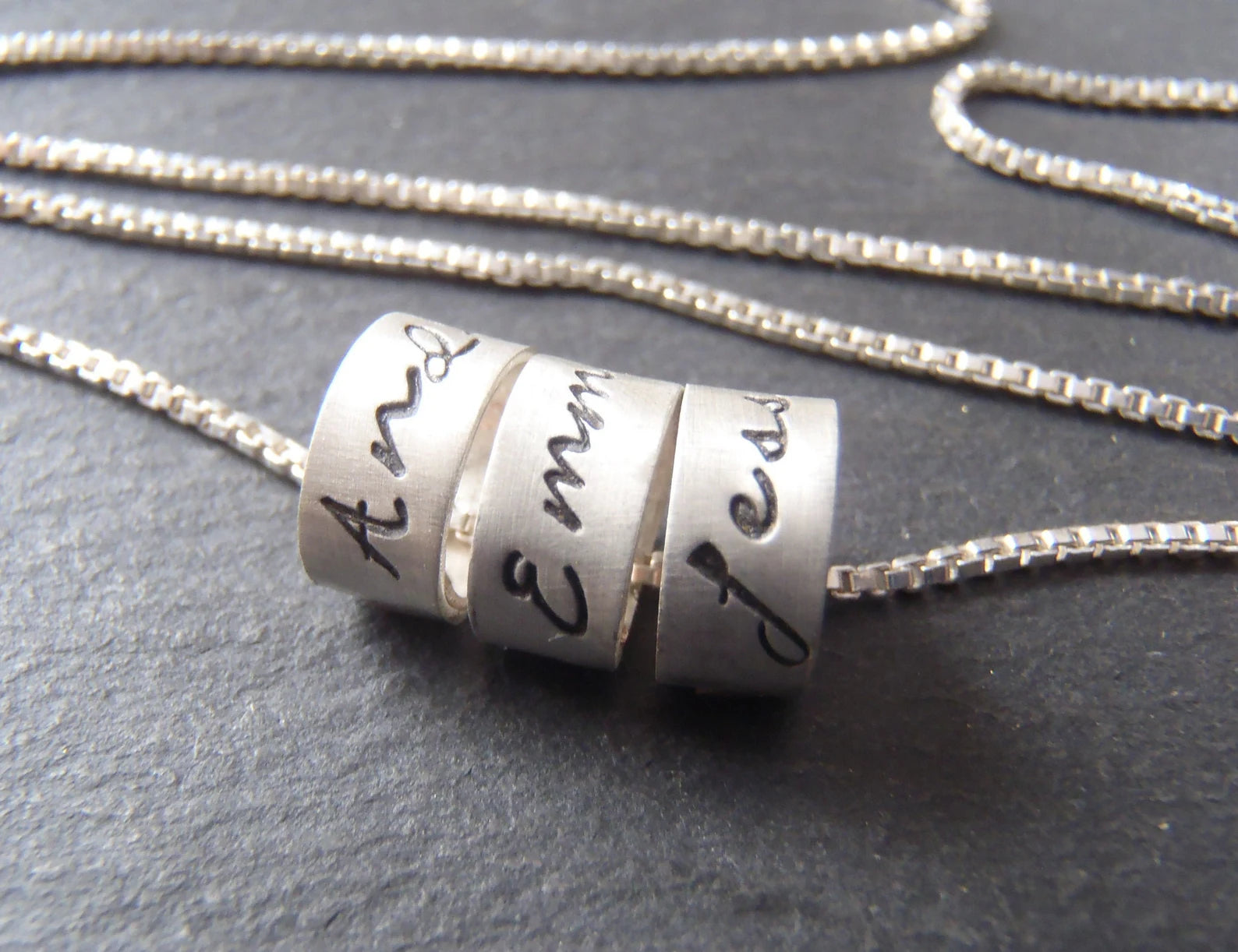 sterling silver mom necklace with kids names in your choice of font on tiny ring charms.  drake designs jewelry