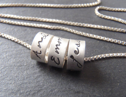 sterling silver mom necklace with kids names in your choice of font on tiny ring charms.  drake designs jewelry